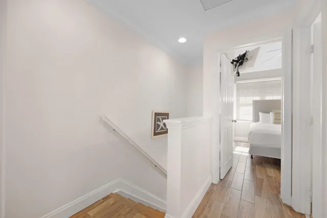 a view of a hallway view with wooden floor and staircase