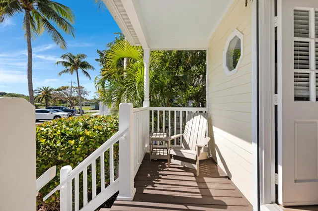 a view of a balcony with wooden floor and fence