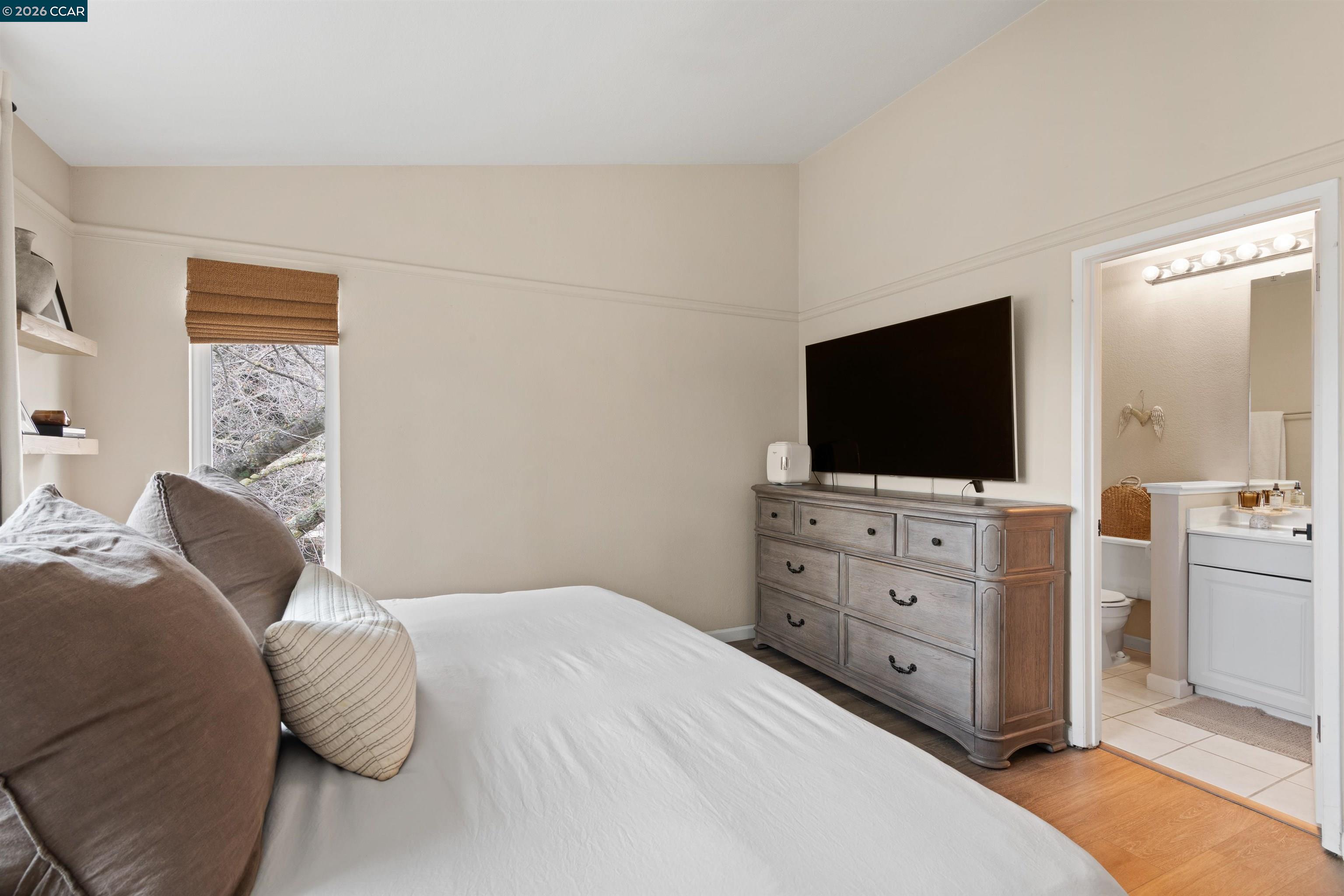 2721 Oak Road, Unit L Walnut Creek, CA 94597 - Photo 15 of 25 a bedroom with a bed and a flat screen tv