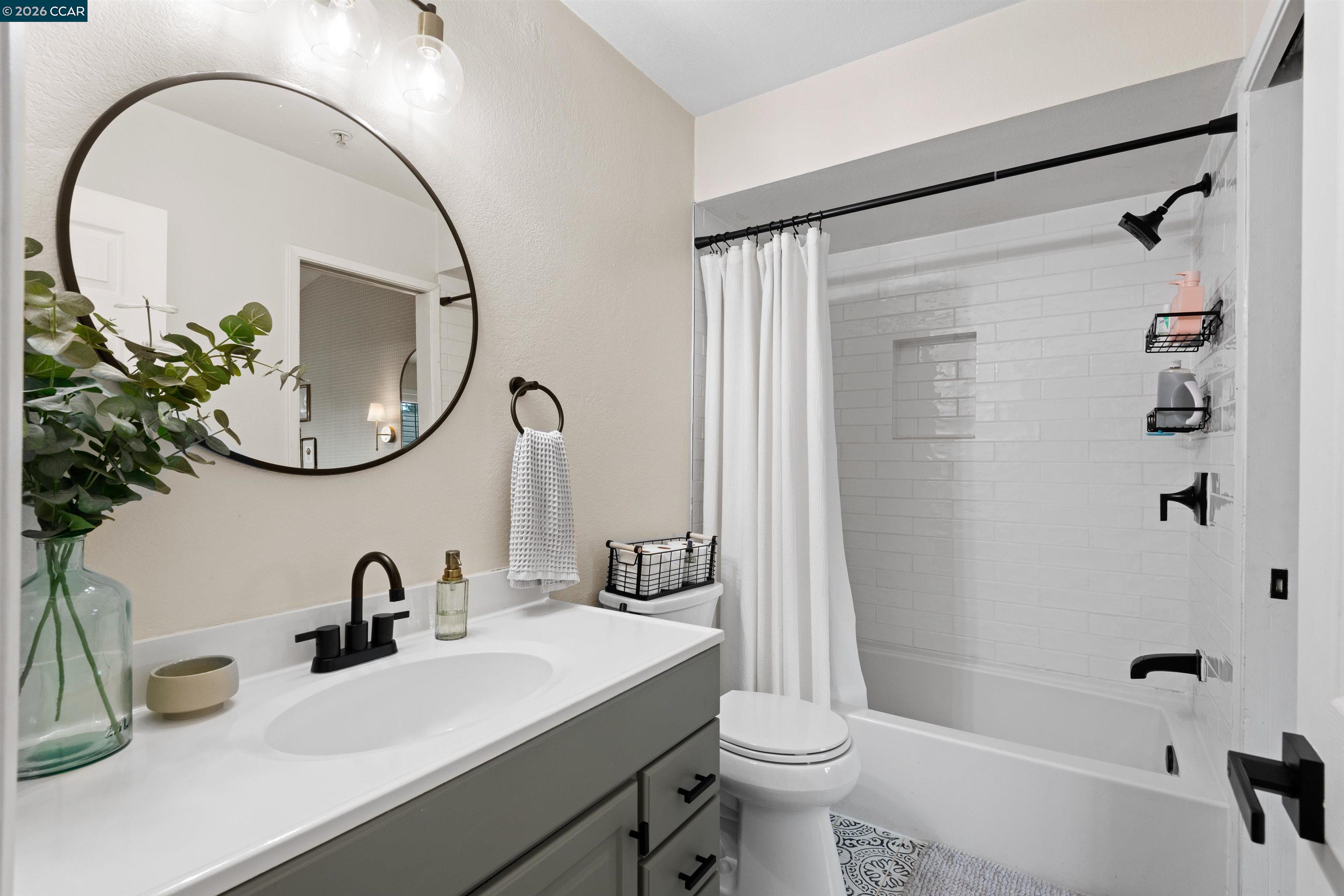 2721 Oak Road, Unit L Walnut Creek, CA 94597 - Photo 19 of 25 a bathroom with a sink a toilet and a mirror
