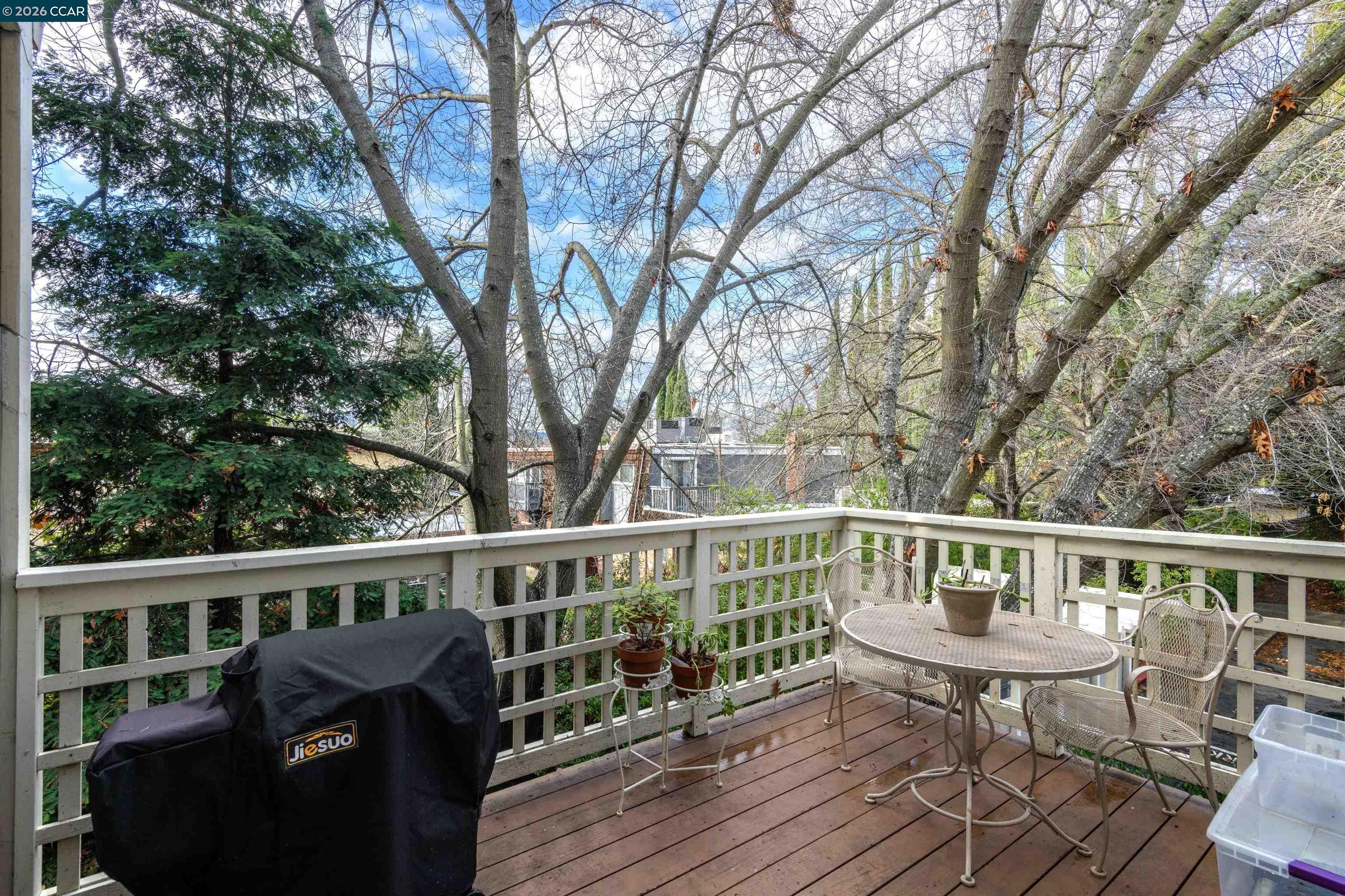 2721 Oak Road, Unit L Walnut Creek, CA 94597 - Photo 9 of 25 a view of a deck with two chair and wooden floor