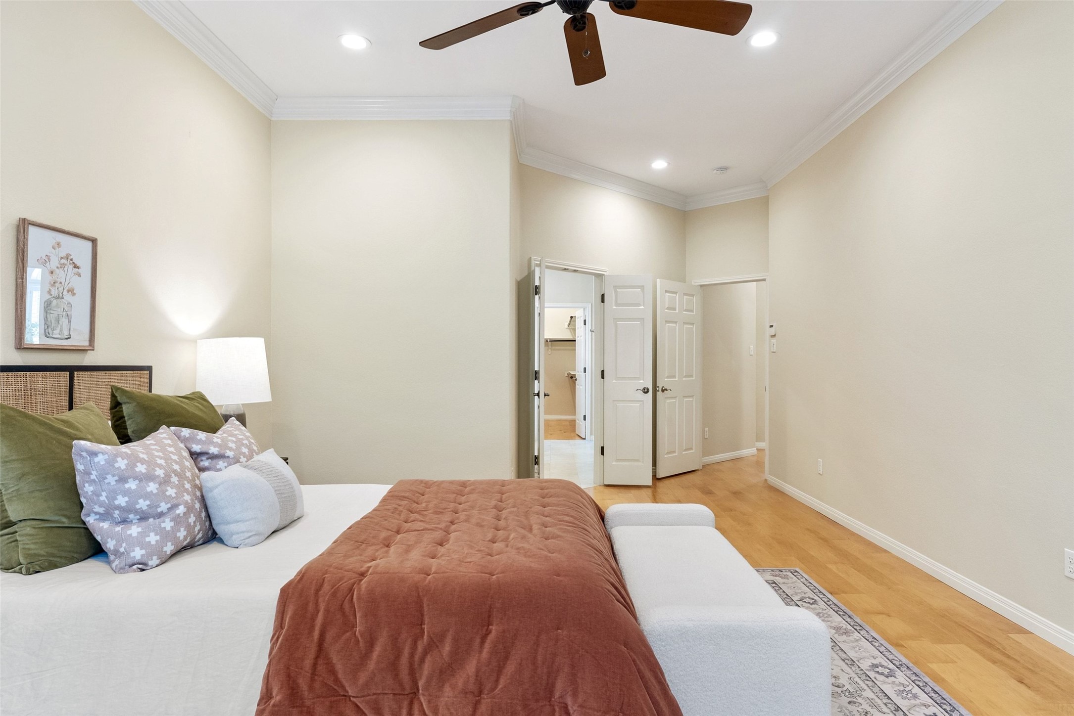 8215 Dark Ridge Cove Austin, TX 78737 - Photo 18 of 40 Hardwood flooring, recessed lighting, and numerous windows define this sun-filled primary bedroom retreat.