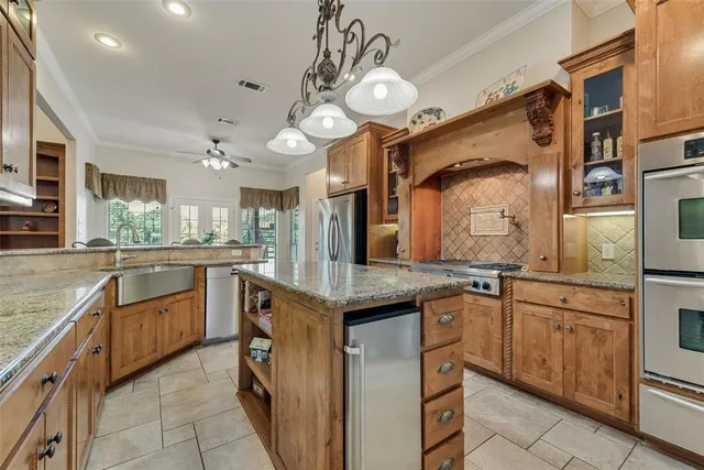 a kitchen with stainless steel appliances granite countertop a sink and cabinets