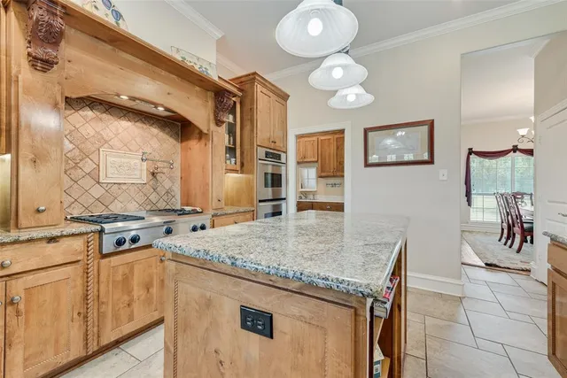 a kitchen with stainless steel appliances granite countertop a stove and a sink