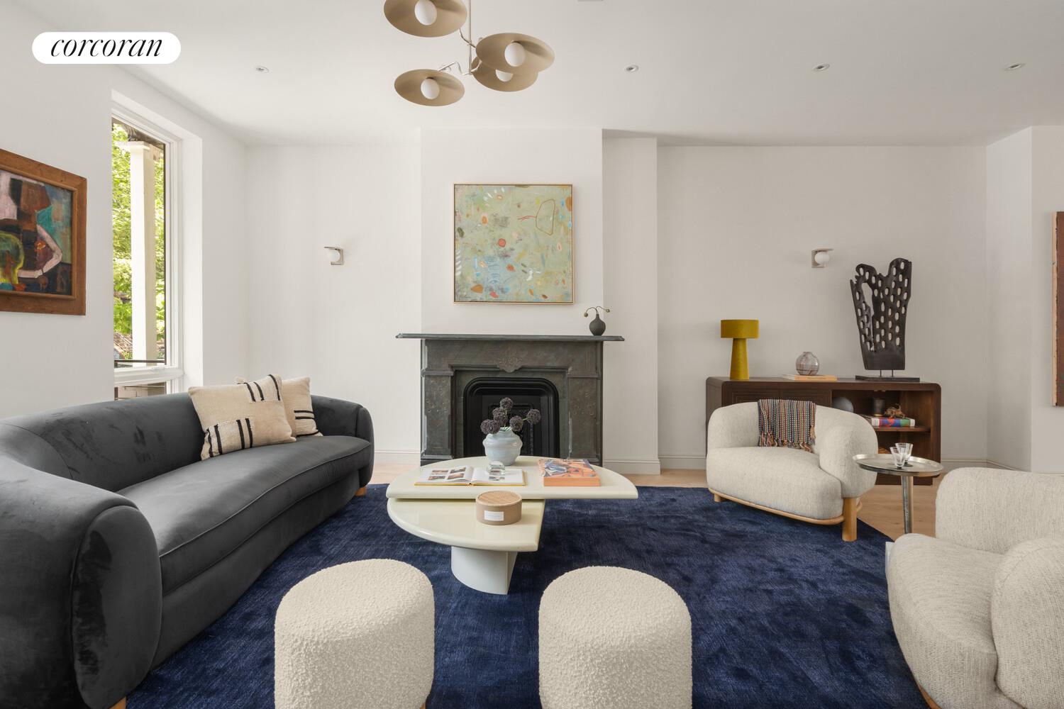 700 Monroe Street Brooklyn, NY 11221 - Photo 2 of 18 a living room with furniture a fireplace and a large window