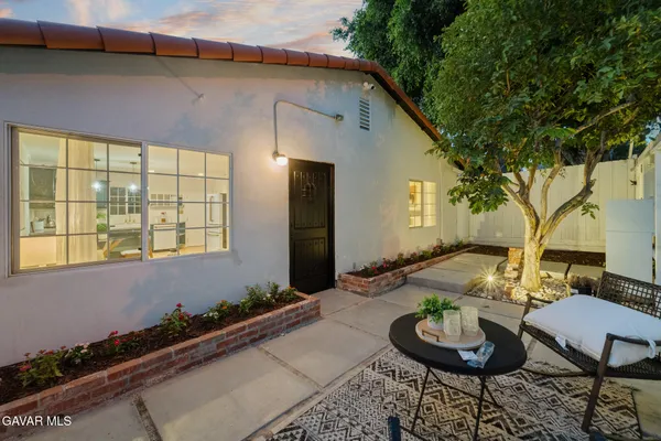 a backyard of a house with fire pit and outdoor seating