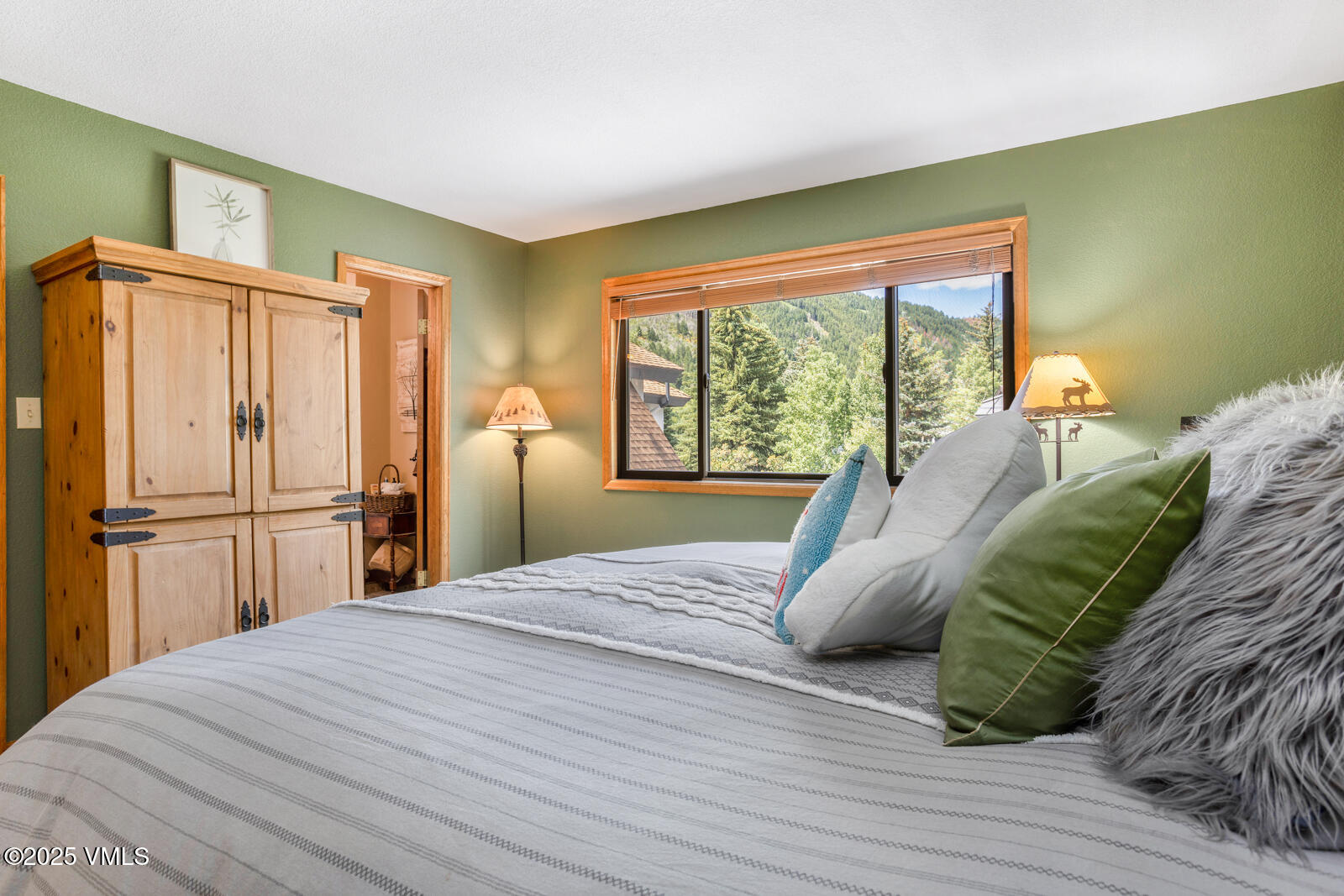 425 Deer Boulevard, Unit B Eagle-Vail, CO 81620 - Photo 15 of 26 a bed sitting in a bedroom next to a window