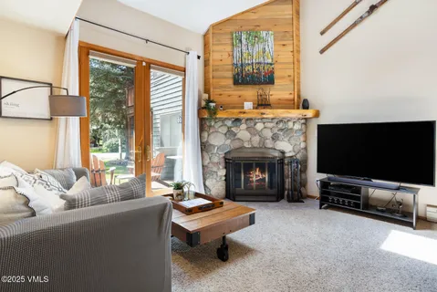 a living room with furniture a flat screen tv and a fireplace