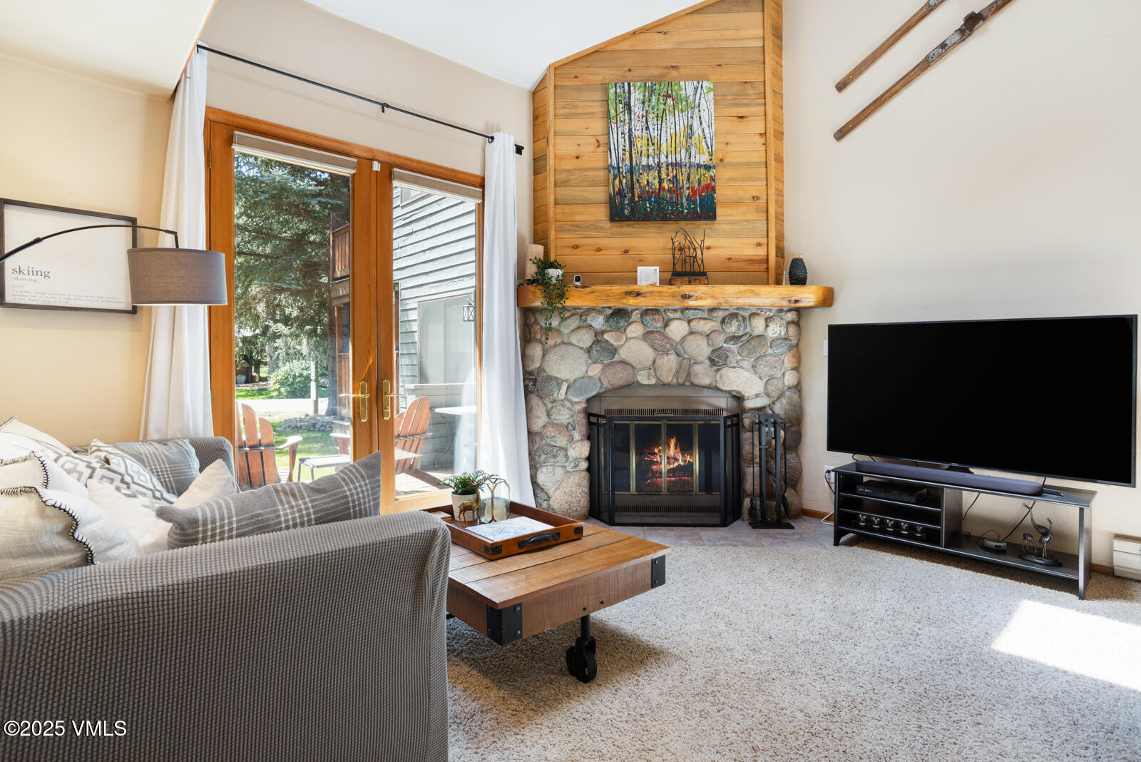 425 Deer Boulevard, Unit B Eagle-Vail, CO 81620 - Photo 2 of 26 a living room with furniture a flat screen tv and a fireplace