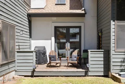 a view of a chairs and table in the balcony