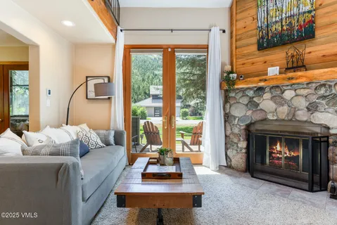 a living room with furniture a fireplace and a table