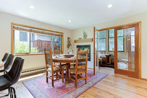 a dining room with furniture window and wooden floor