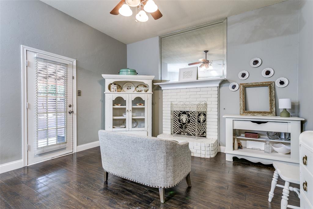 2133 Rim Rock Drive Keller, TX 76248 - Photo 13 of 37 Living room featuring dark wood-type flooring, a ceiling fan, and a brick fireplace