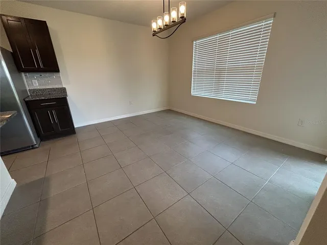 a large kitchen with a large counter top stainless steel appliances and cabinets