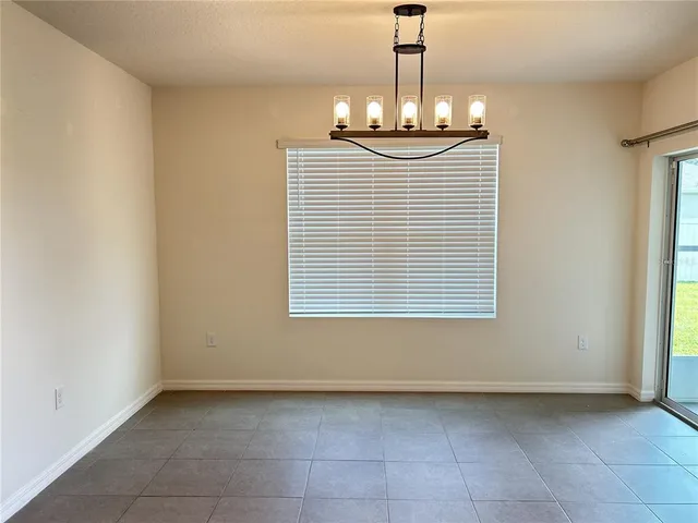 a kitchen with granite countertop a stove microwave and sink