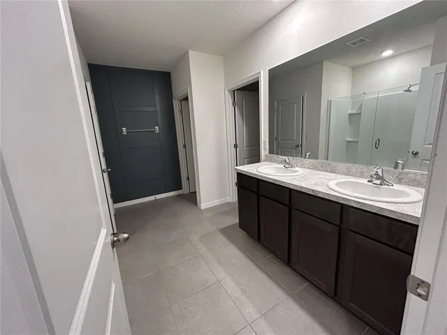 an empty room with closet and windows