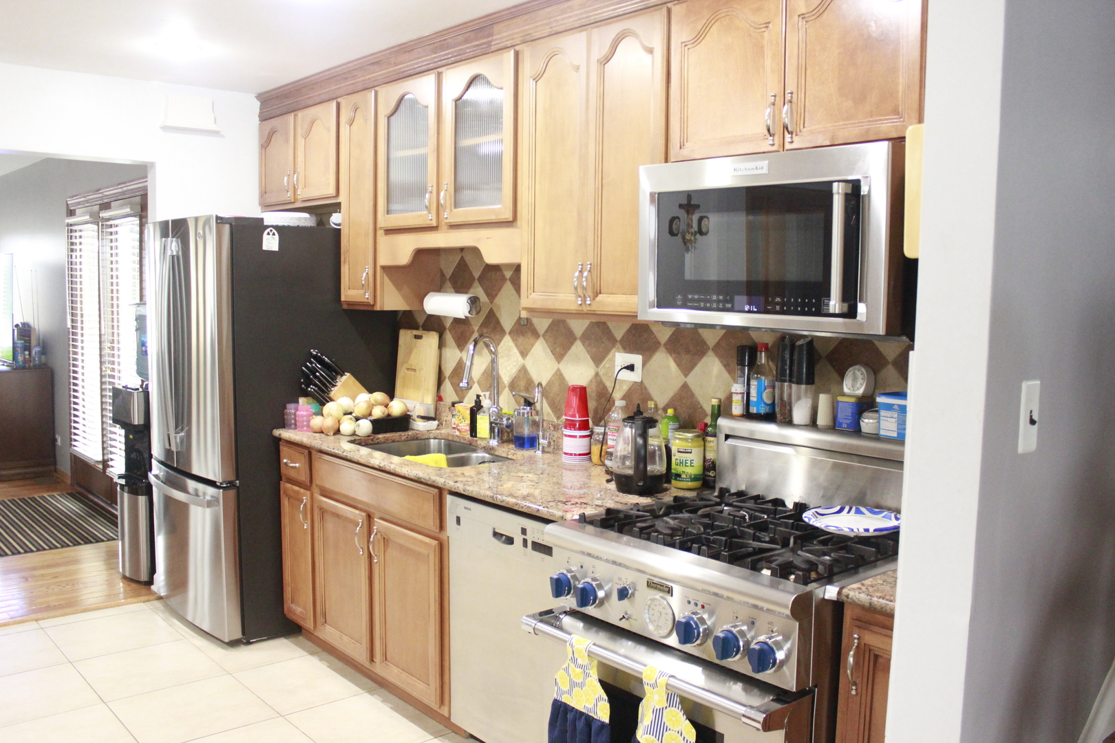 5639 Manor Lane Chicago, IL 60631 - Photo 12 of 29 a kitchen with stainless steel appliances granite countertop a stove a refrigerator and a microwave