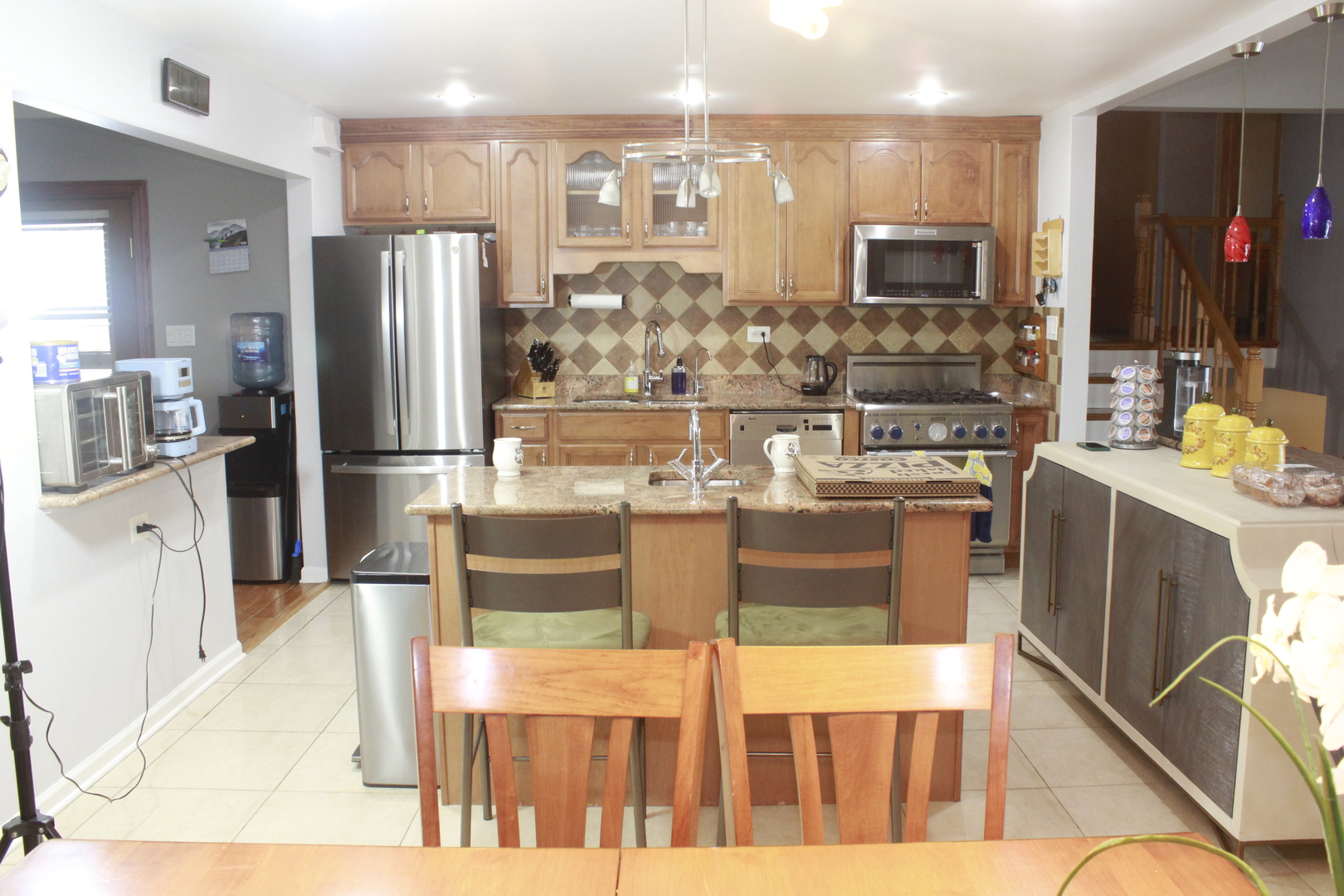 5639 Manor Lane Chicago, IL 60631 - Photo 14 of 29 a kitchen with stainless steel appliances kitchen island granite countertop a refrigerator a stove top oven and a sink