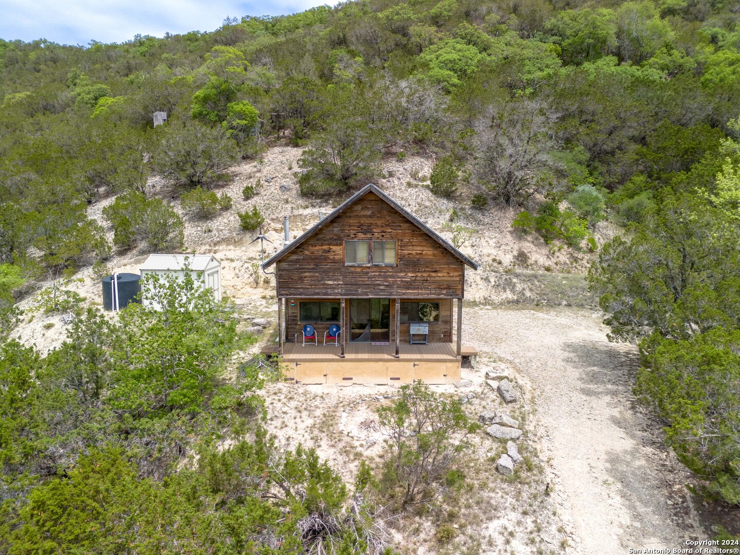 a view of house with yard and mountain view in back