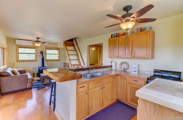 a kitchen with a sink appliances and a window