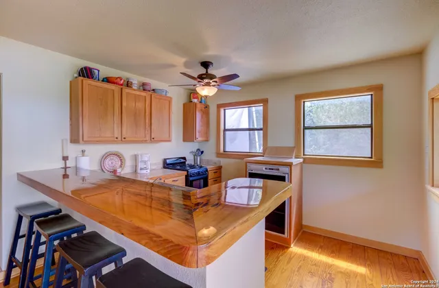 a kitchen with a sink appliances and a window