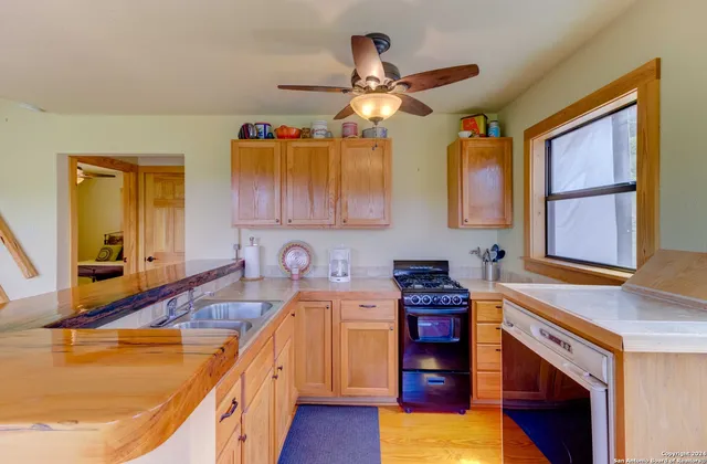 a kitchen with stainless steel appliances granite countertop a sink and cabinets