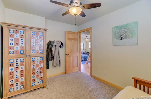 a view of a livingroom with furniture and a ceiling fan