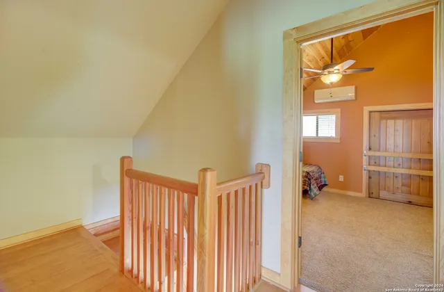 a view of empty room with wooden floor and cabinet