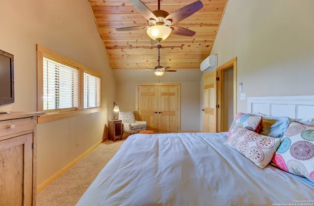 a bedroom with a large bed and a chandelier
