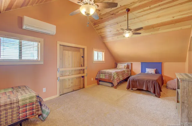 a spacious bedroom with a bed and ceiling fan