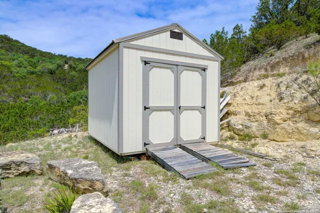 a view of a small house with a small yard