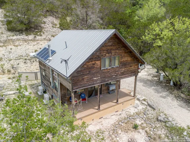 a view of house with yard and sitting area
