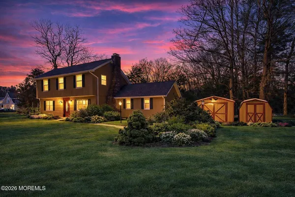 a front view of a house with a garden