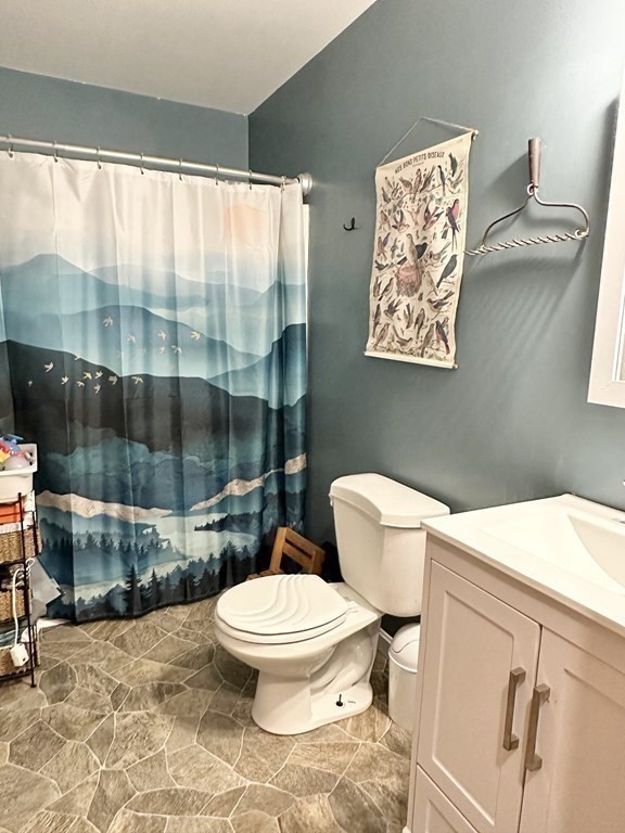 1388 Westhampton Road Northampton, MA 01062 - Photo 13 of 28 a white toilet sitting next to a bathroom sink and a shower