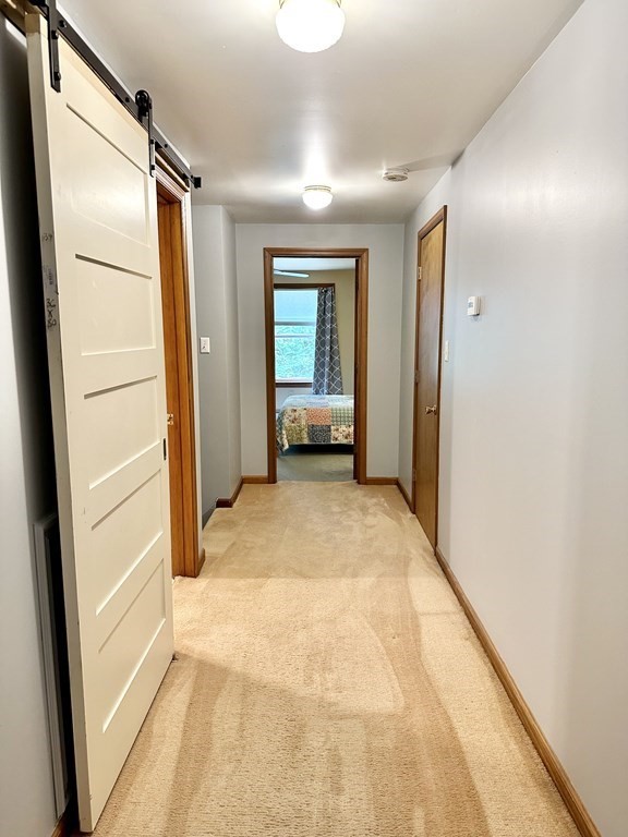 1388 Westhampton Road Northampton, MA 01062 - Photo 20 of 28 a view of a hallway with wooden floor and furniture