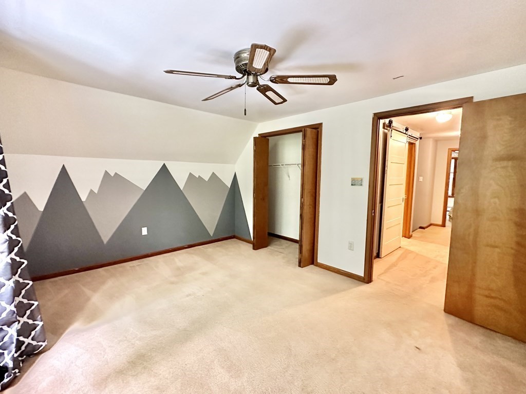 1388 Westhampton Road Northampton, MA 01062 - Photo 21 of 28 a view of a room with closet and a ceiling fan