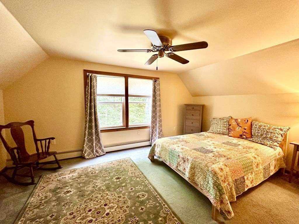 1388 Westhampton Road Northampton, MA 01062 - Photo 25 of 28 a bedroom with a bed a chair and next to a window