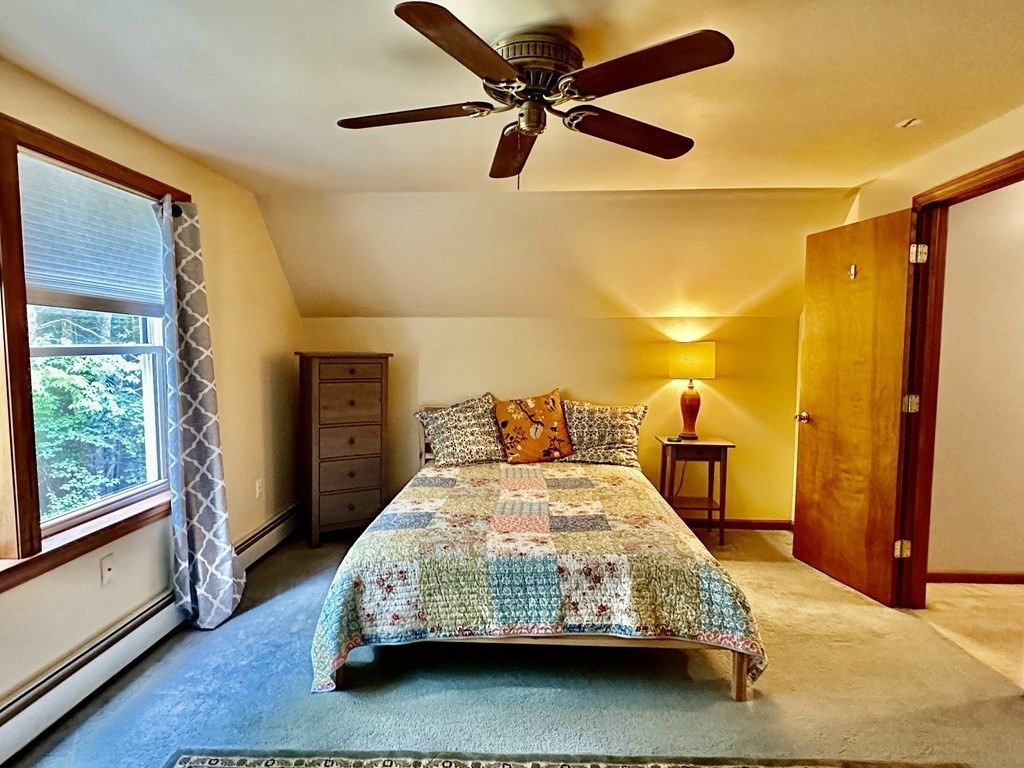1388 Westhampton Road Northampton, MA 01062 - Photo 26 of 28 a bedroom with a bed mirror and a window
