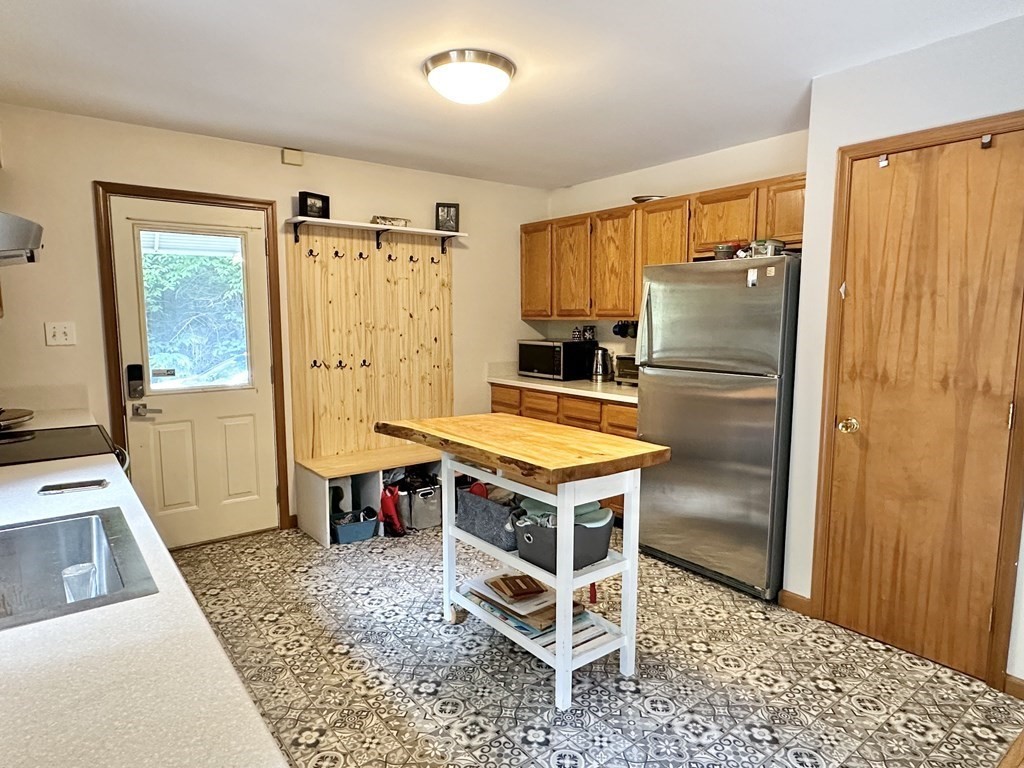 1388 Westhampton Road Northampton, MA 01062 - Photo 3 of 28 a living room with a table wooden floor and a window
