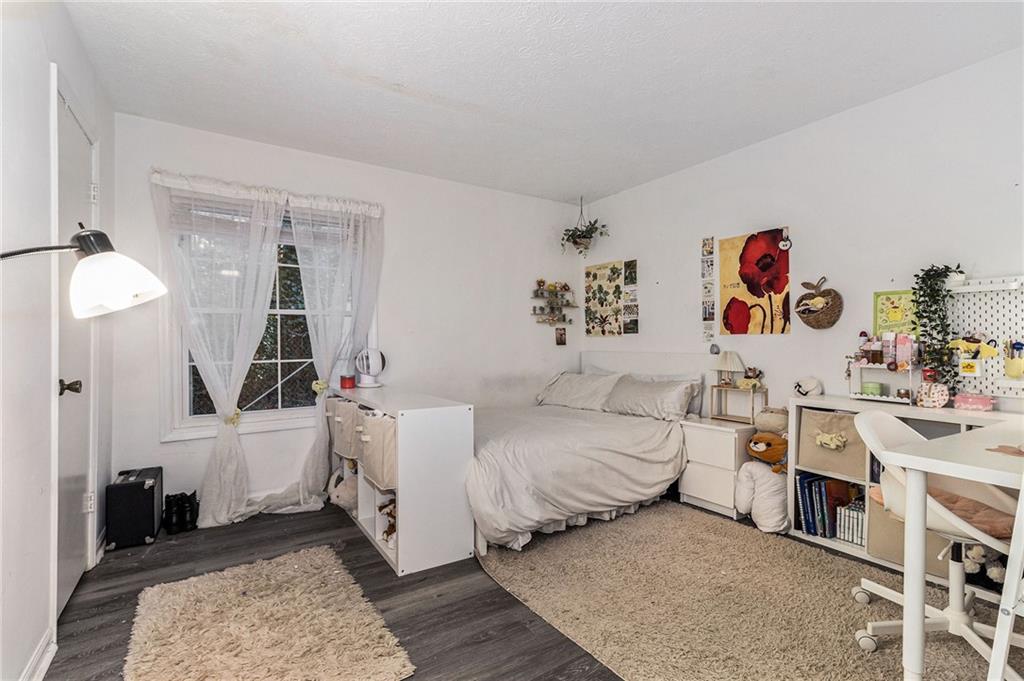 725 Dalrymple Road, Unit 3H Atlanta, GA 30328 - Photo 12 of 17 a bedroom with a bed and a couch