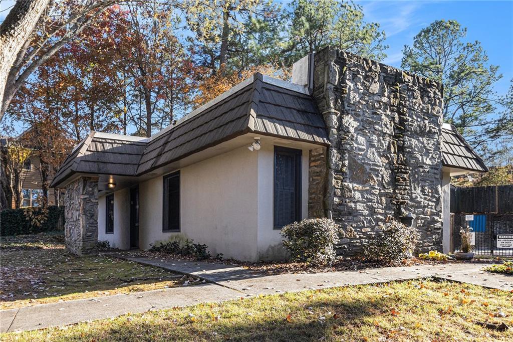 725 Dalrymple Road, Unit 3H Atlanta, GA 30328 - Photo 16 of 17 a view of a house with a yard