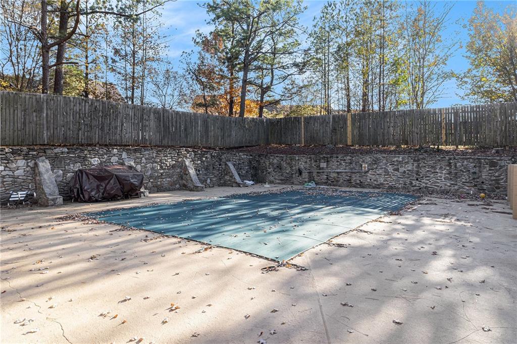 725 Dalrymple Road, Unit 3H Atlanta, GA 30328 - Photo 17 of 17 a view of a backyard with large tree and wooden fence