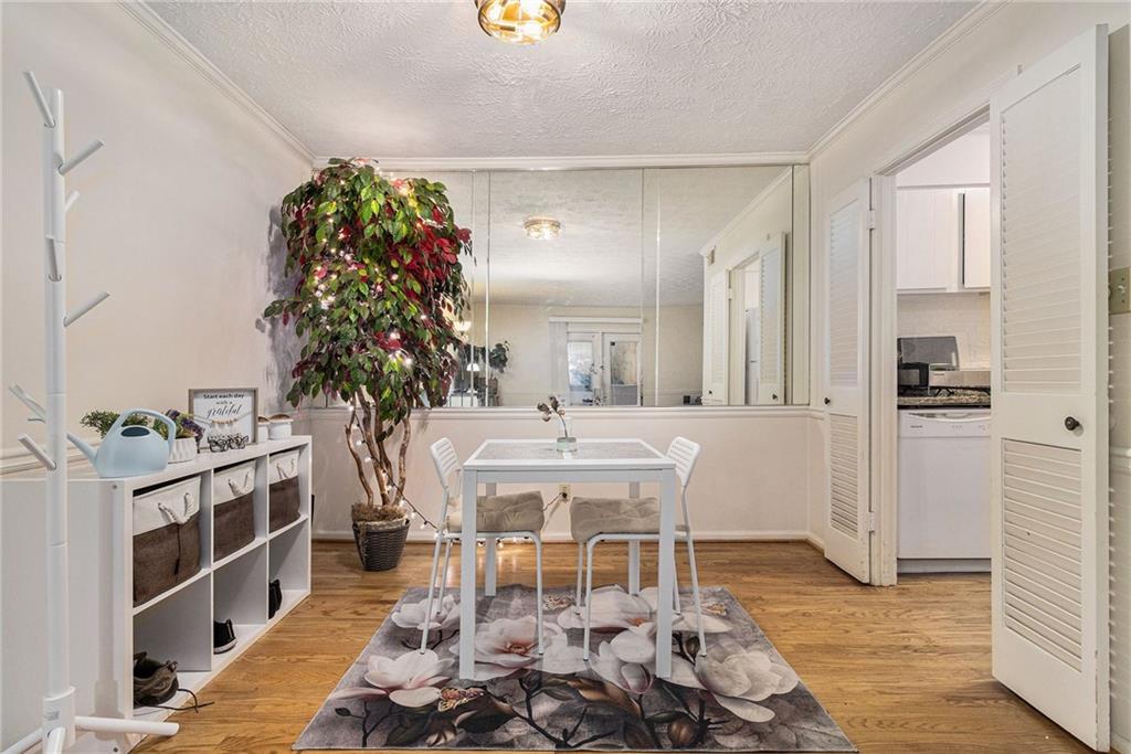 725 Dalrymple Road, Unit 3H Atlanta, GA 30328 - Photo 6 of 17 a dining room with furniture and wooden floor