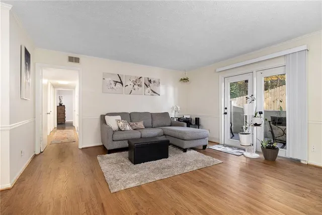 a living room with furniture and a wooden floor
