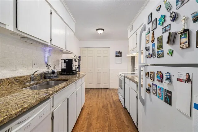 a kitchen with stainless steel appliances granite countertop lots of counter top space and cabinets