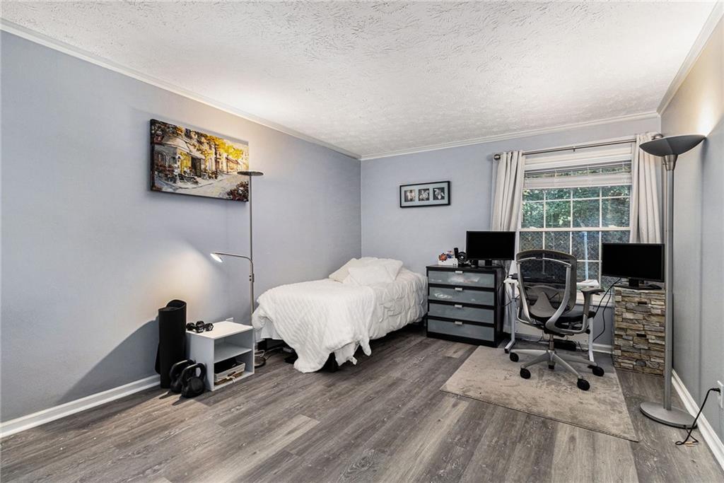 725 Dalrymple Road, Unit 3H Atlanta, GA 30328 - Photo 10 of 17 a spacious bedroom with a bed and a desk