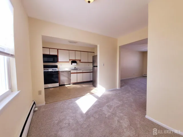 a kitchen with stainless steel appliances granite countertop a refrigerator sink and cabinets