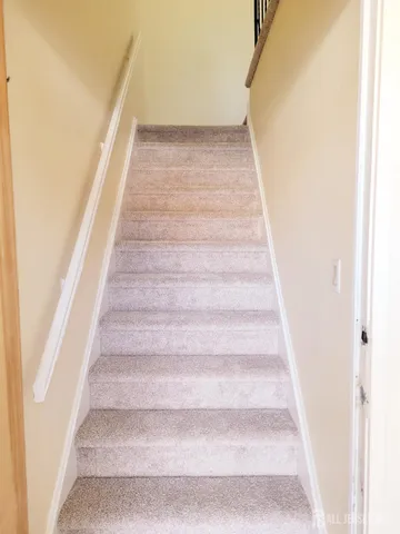 a view of staircase with white walls