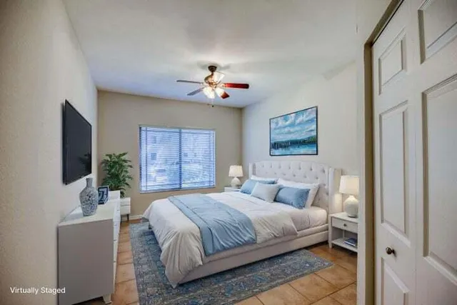 a bedroom with a large bed and a flat screen tv