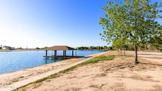 a view of swimming pool with a yard and lake view